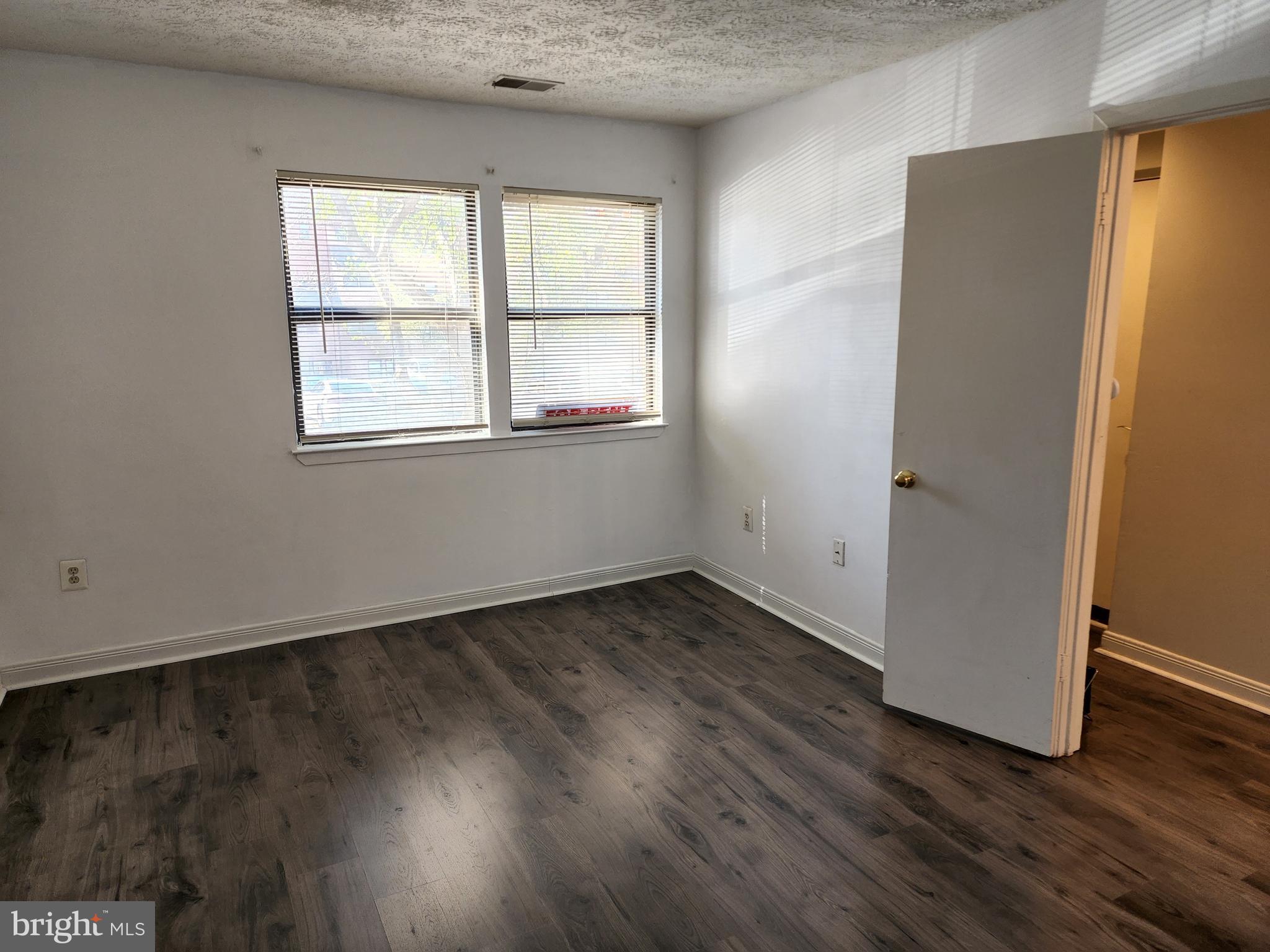7603 Weather Worn Way, Unit F Columbia, MD 21046 - Photo 12 of 17 an empty room with wooden floor and windows