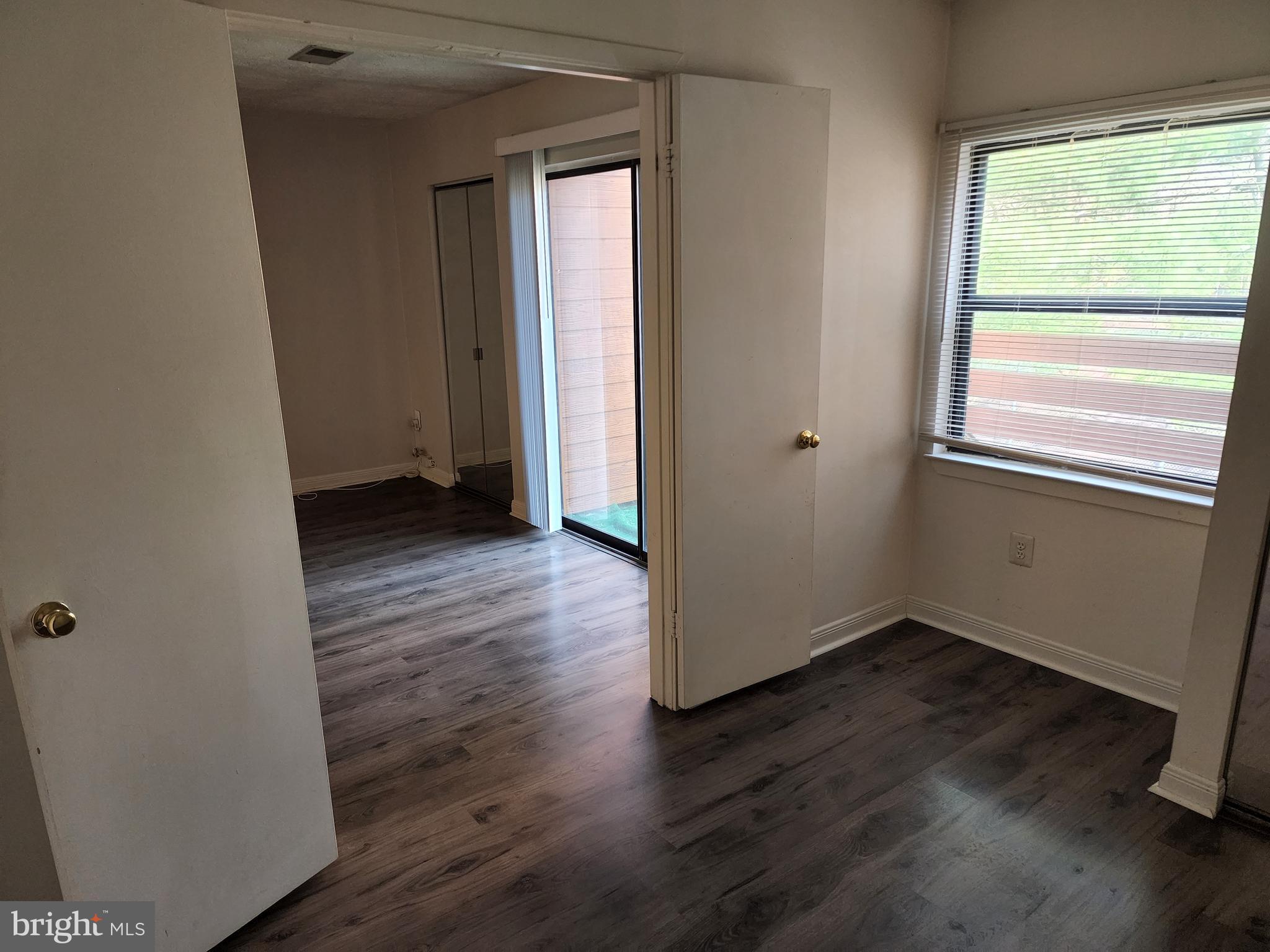 7603 Weather Worn Way, Unit F Columbia, MD 21046 - Photo 15 of 17 a view of an empty room with wooden floor and a window