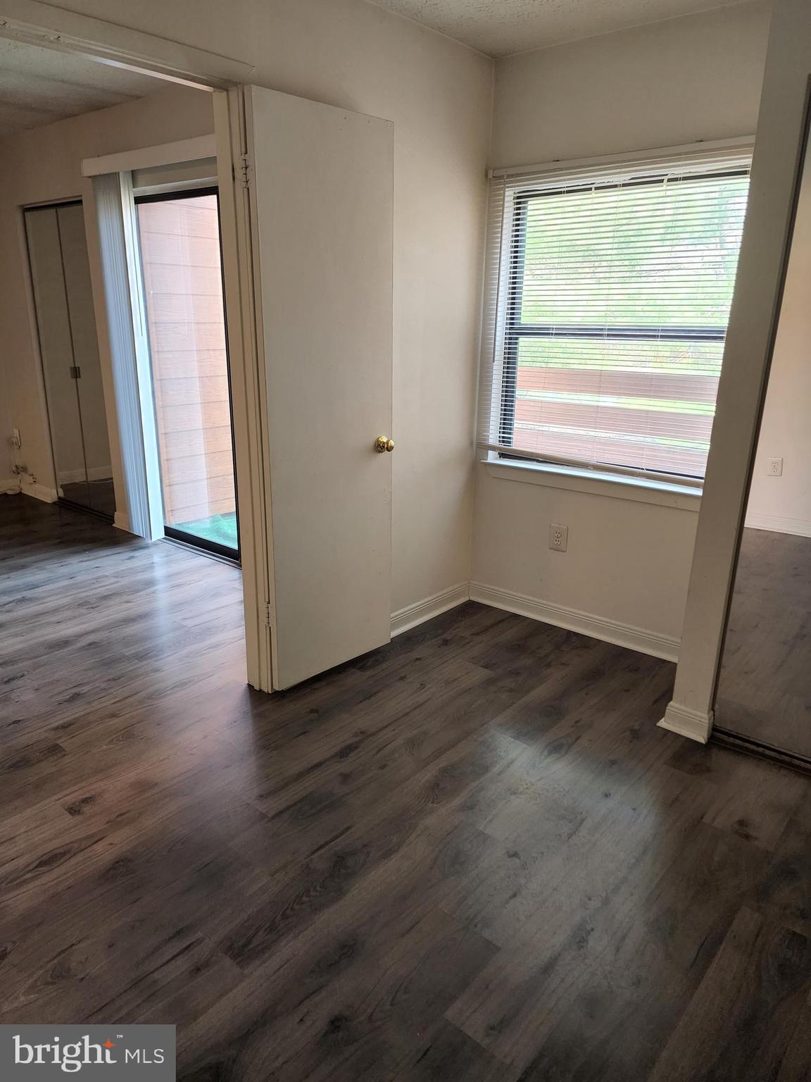 7603 Weather Worn Way, Unit F Columbia, MD 21046 - Photo 16 of 17 a view of a room with wooden floor and a window
