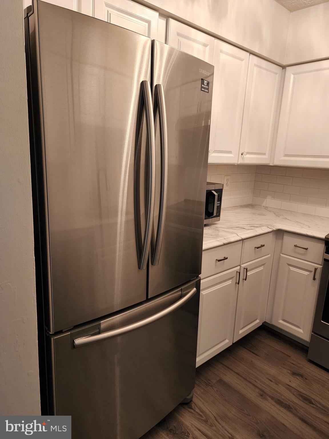 7603 Weather Worn Way, Unit F Columbia, MD 21046 - Photo 8 of 17 a white refrigerator freezer sitting inside of a kitchen