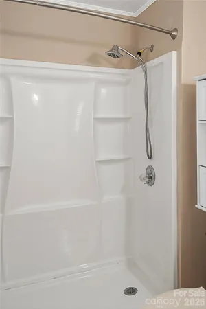 an empty room with wooden floor and ceiling fan