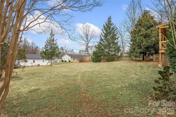 a view of house with backyard