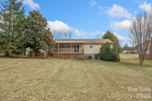 a view of a balcony with chairs and wooden floor