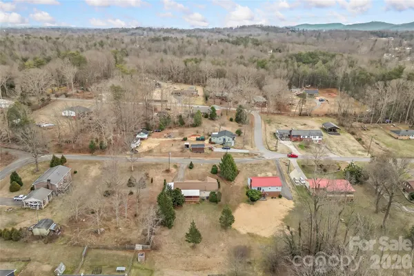 a view of a field of grass and trees