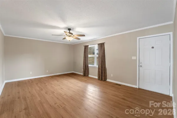 a kitchen with refrigerator cabinets and wooden floor
