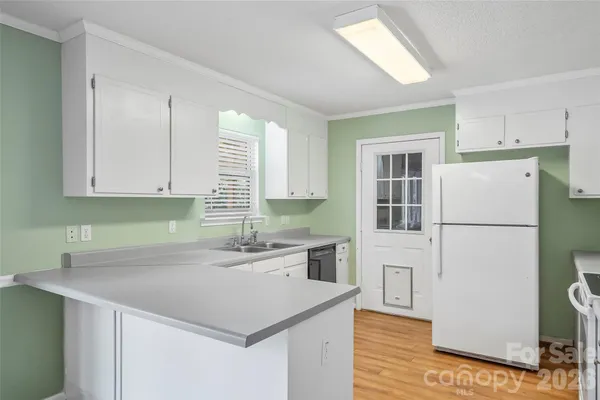 a view of room with window and wooden floor