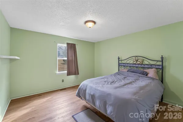 a bedroom with a bed and a table