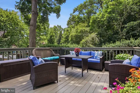 a roof deck with couches and wooden floor