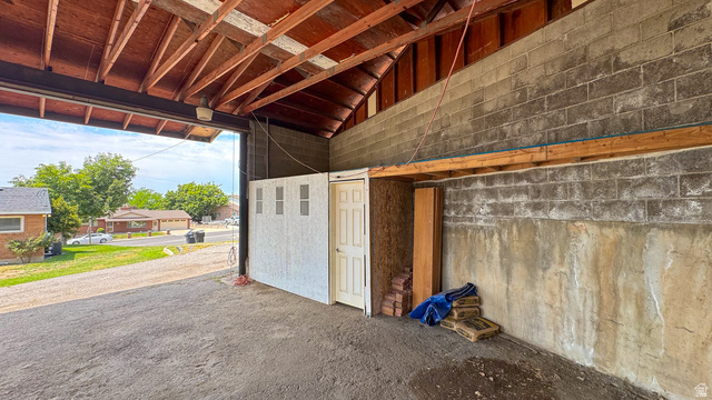 120 North 1230 E Street Springville, UT 84663 - Photo 42 of 60 Sheltered open-air structure featuring a partial block wall, exposed timber rafters, and a paved ground surface
