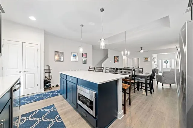a kitchen with a sink a counter top space and stainless steel appliances