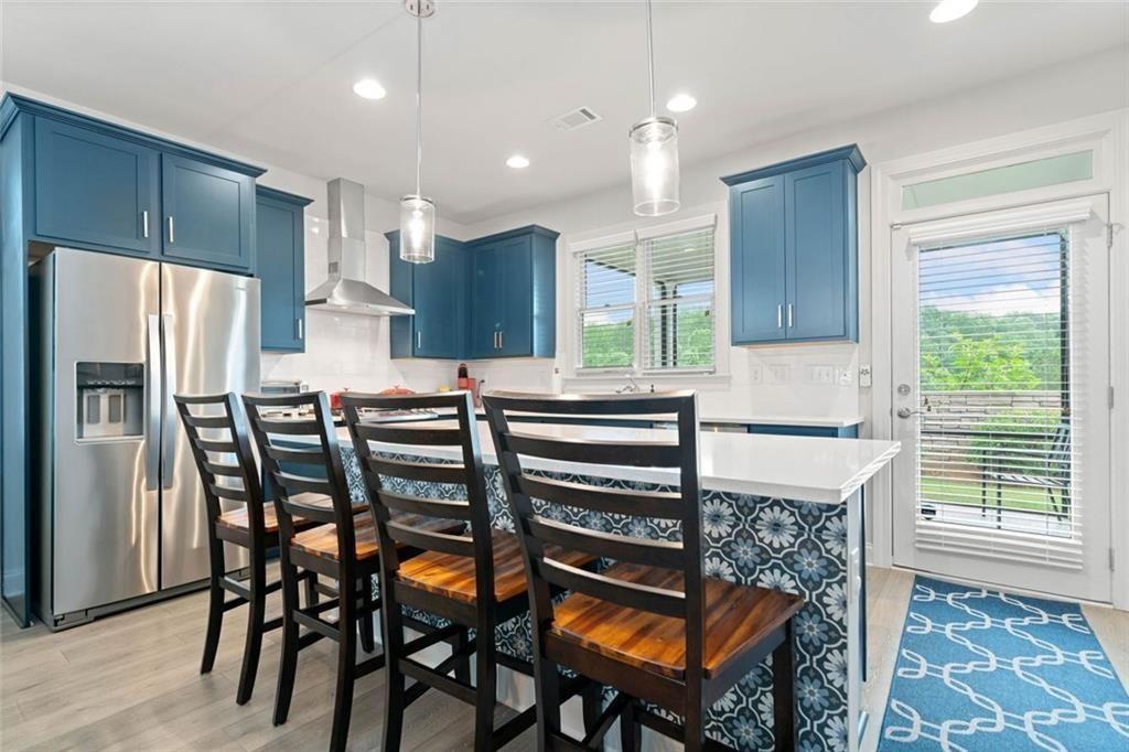 19 Grand Circle Jasper, GA 30143 - Photo 13 of 36 a kitchen with stainless steel appliances kitchen island granite countertop a table chairs and a refrigerator