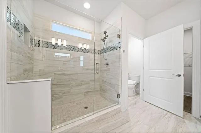 a bathroom with a glass shower door