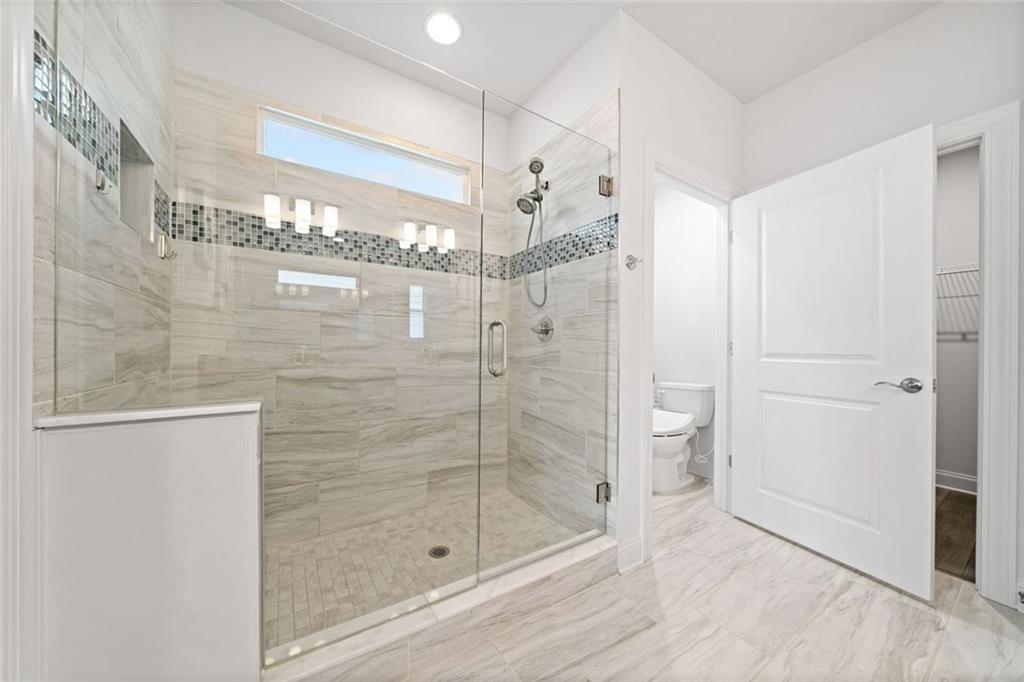 19 Grand Circle Jasper, GA 30143 - Photo 20 of 36 a bathroom with a glass shower door