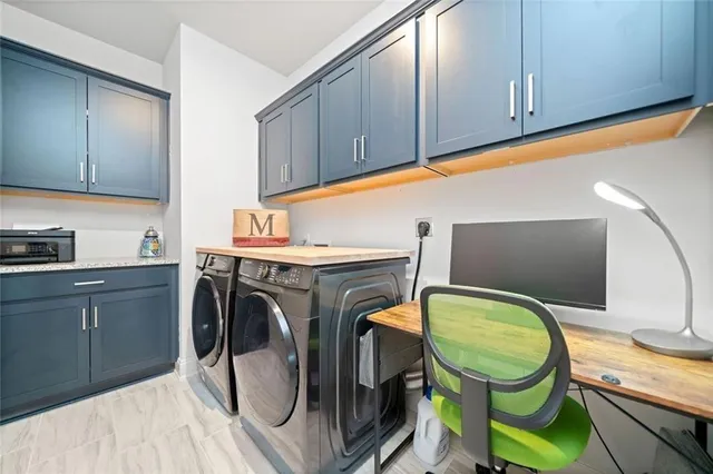 a utility room with sink dryer and washer
