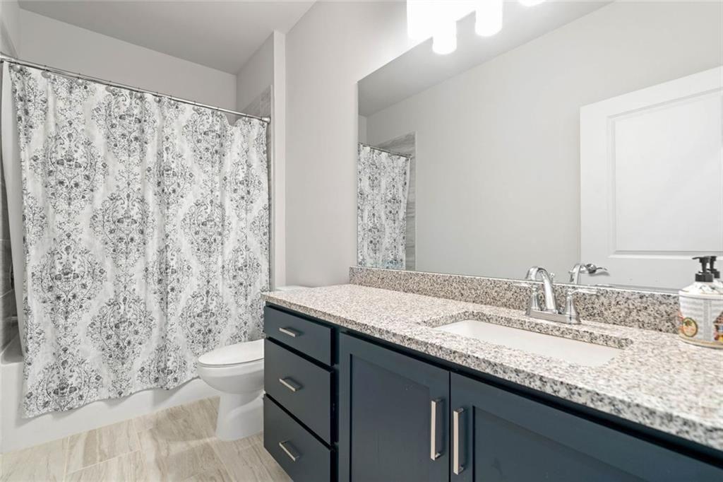 19 Grand Circle Jasper, GA 30143 - Photo 24 of 36 a bathroom with a granite countertop sink a toilet and a mirror