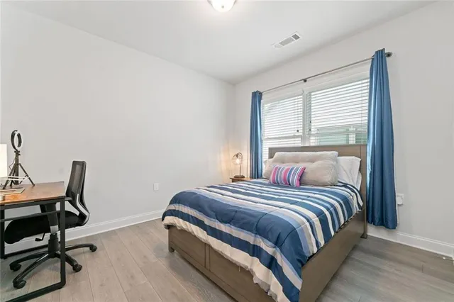 a bedroom with a bed a desk and chair