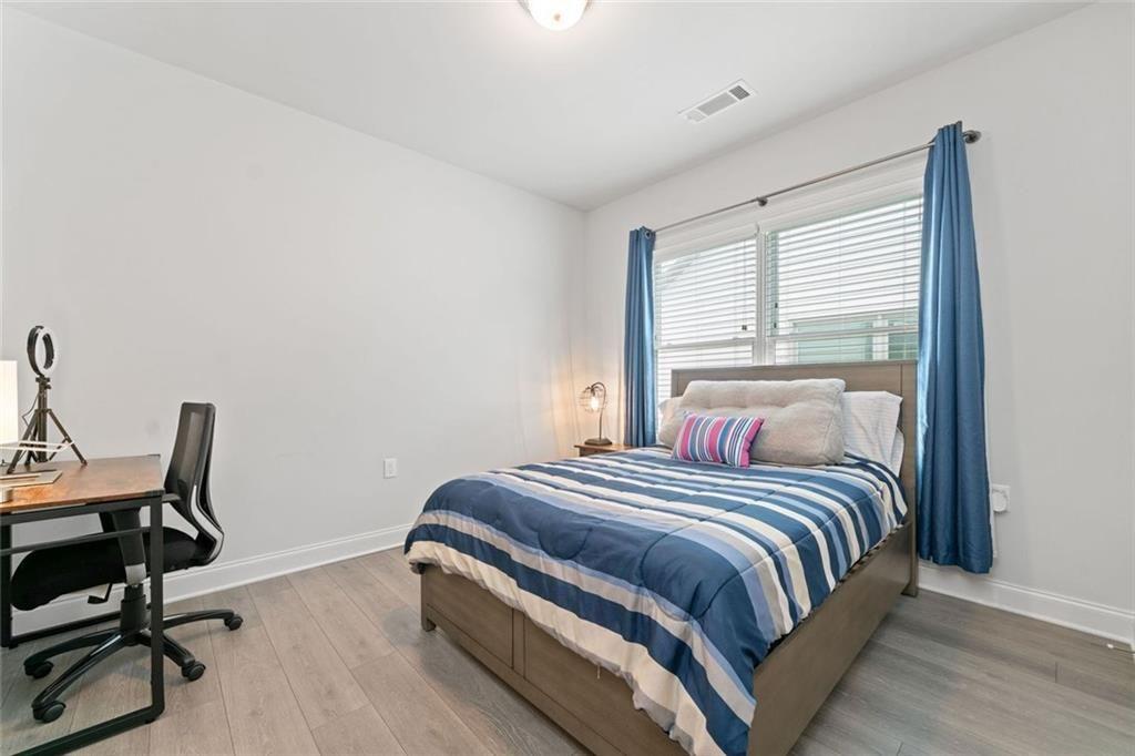 19 Grand Circle Jasper, GA 30143 - Photo 26 of 36 a bedroom with a bed a desk and chair