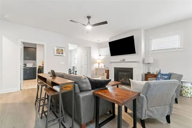 a living room with furniture a fireplace and a flat screen tv