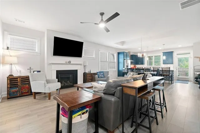 a living room with furniture a fireplace and a flat screen tv