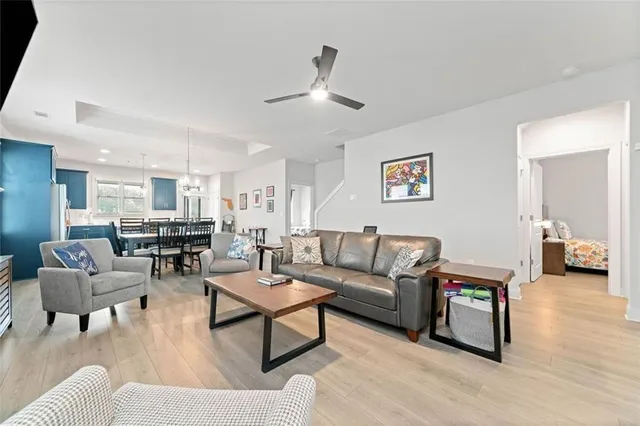 a living room with furniture and view of kitchen