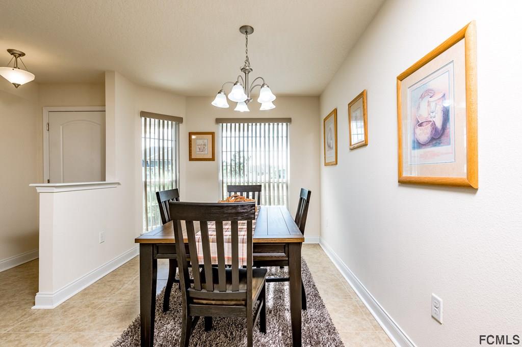 20 Turtle Ridge Drive Flagler Beach, FL 32136 - Photo 13 of 47 a view of a dining room with furniture window and wooden floor