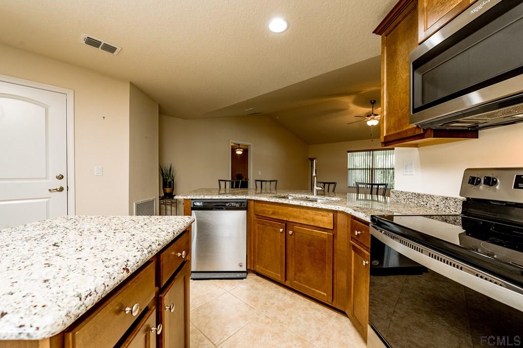 20 Turtle Ridge Drive Flagler Beach, FL 32136 - Photo 15 of 47 a kitchen with a sink and cabinets