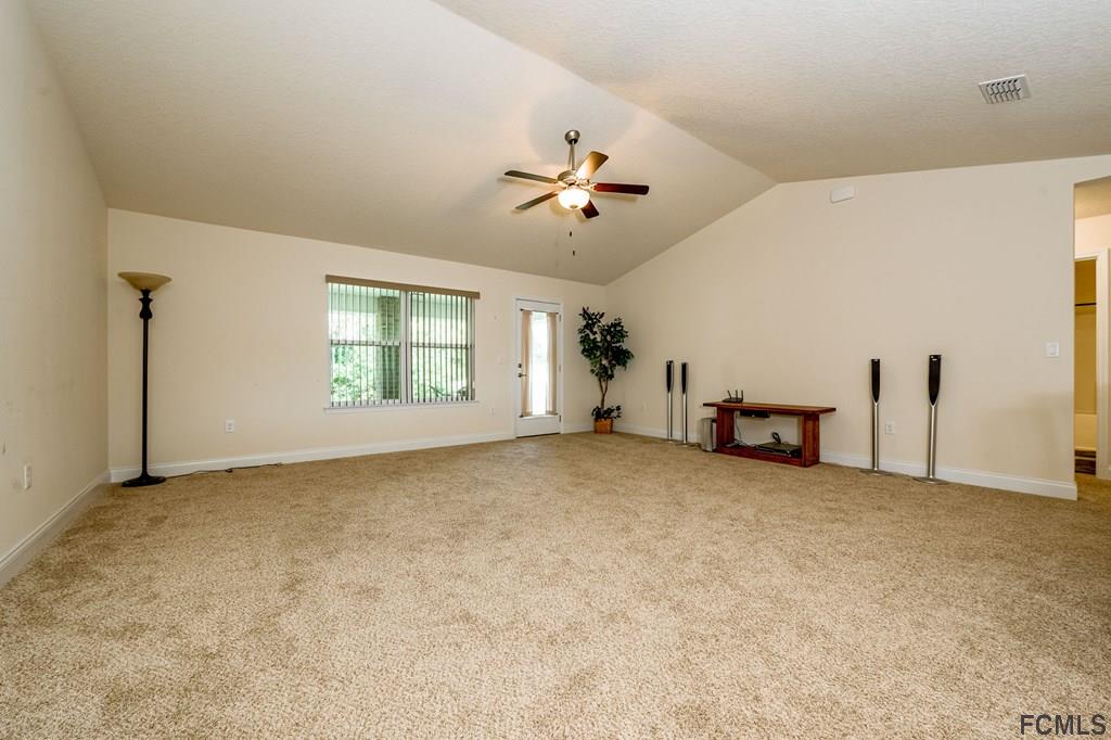 20 Turtle Ridge Drive Flagler Beach, FL 32136 - Photo 19 of 47 an empty room with windows and ceiling fan view