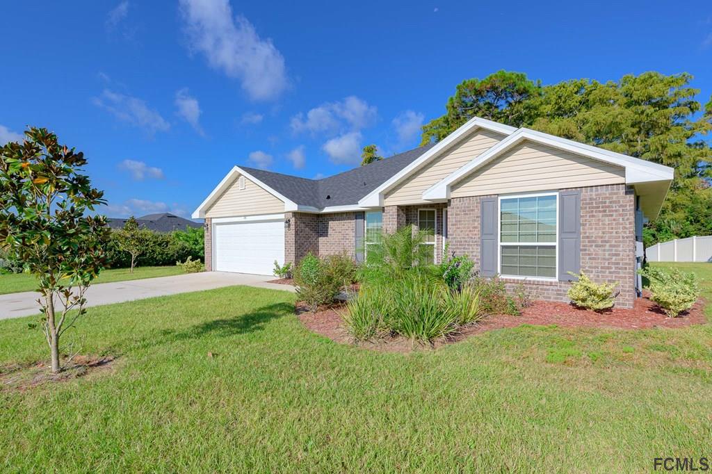 20 Turtle Ridge Drive Flagler Beach, FL 32136 - Photo 3 of 47 a front view of a house with garden