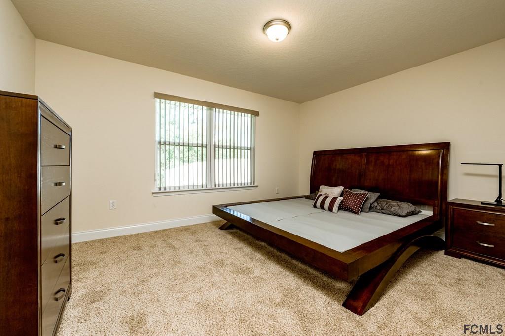 20 Turtle Ridge Drive Flagler Beach, FL 32136 - Photo 25 of 47 a living room with furniture and a flat screen tv