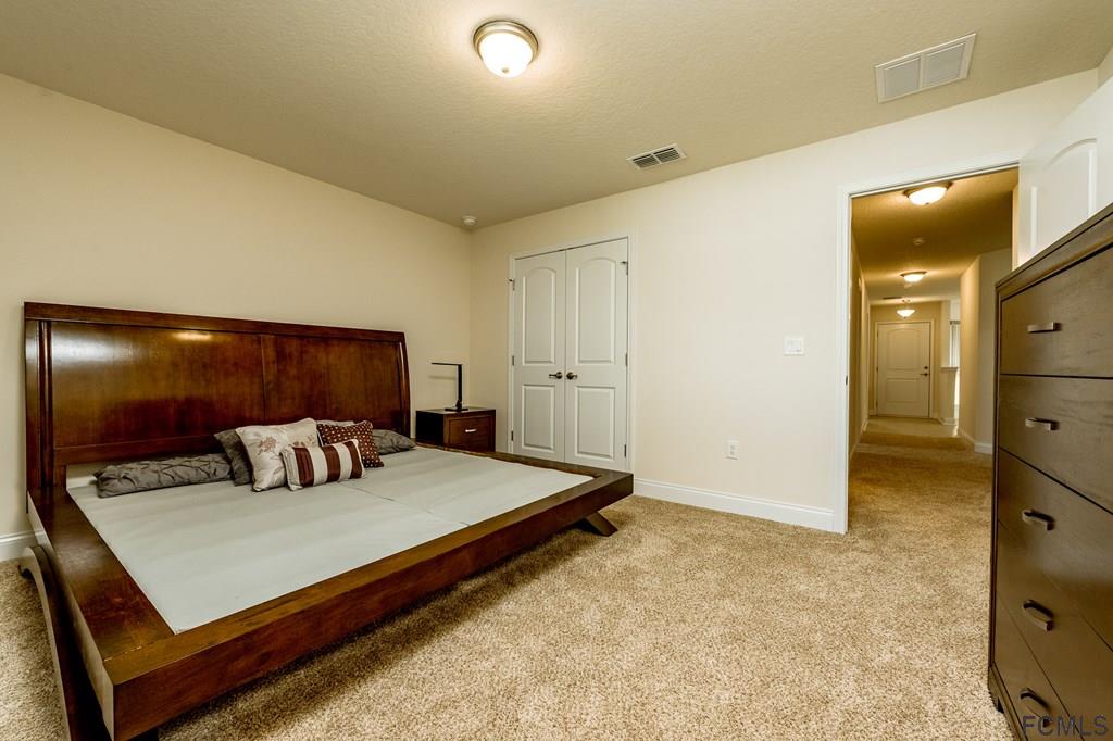 20 Turtle Ridge Drive Flagler Beach, FL 32136 - Photo 26 of 47 a bedroom with a bed and lamp