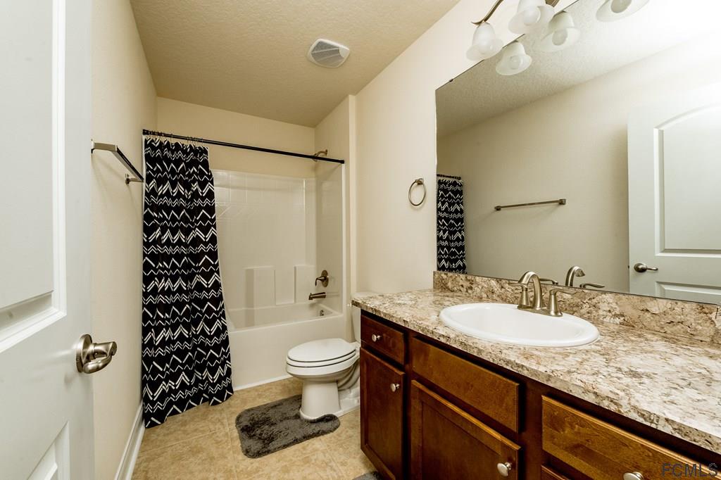 20 Turtle Ridge Drive Flagler Beach, FL 32136 - Photo 27 of 47 a bathroom with a granite countertop sink toilet mirror and shower