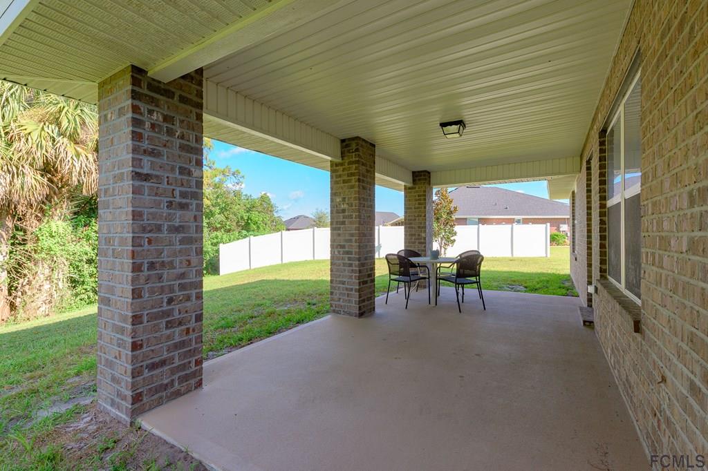 20 Turtle Ridge Drive Flagler Beach, FL 32136 - Photo 10 of 47 a view of a porch with chairs and backyard