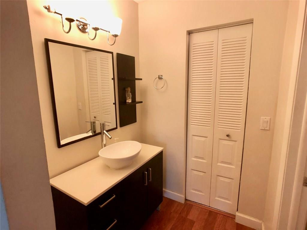 10026 Winding Lake Road, Unit 102 Sunrise, FL 33351 - Photo 14 of 23 a bathroom with a sink a mirror and a shower