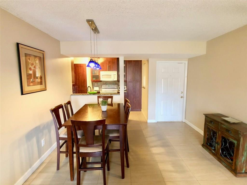 10026 Winding Lake Road, Unit 102 Sunrise, FL 33351 - Photo 5 of 23 a view of a dining room with furniture