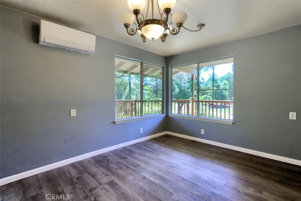 4949 Indian Peak Road Mariposa, CA 95338 - Photo 13 of 56 a view of wooden floor and a chandelier fan in a room