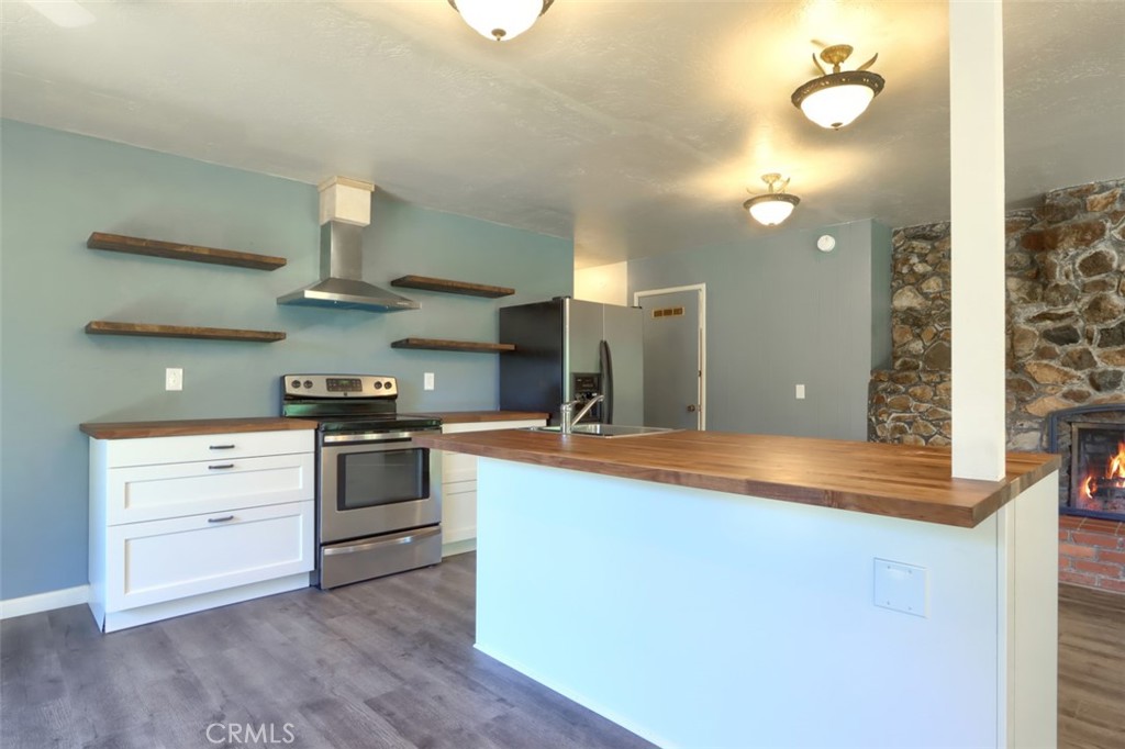 4949 Indian Peak Road Mariposa, CA 95338 - Photo 15 of 56 a kitchen with stainless steel appliances granite countertop a sink and a stove