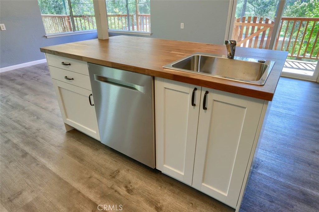 4949 Indian Peak Road Mariposa, CA 95338 - Photo 17 of 56 a kitchen with a sink cabinets and wooden floor