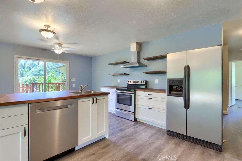 4949 Indian Peak Road Mariposa, CA 95338 - Photo 18 of 56 a kitchen with stainless steel appliances a refrigerator sink and stove