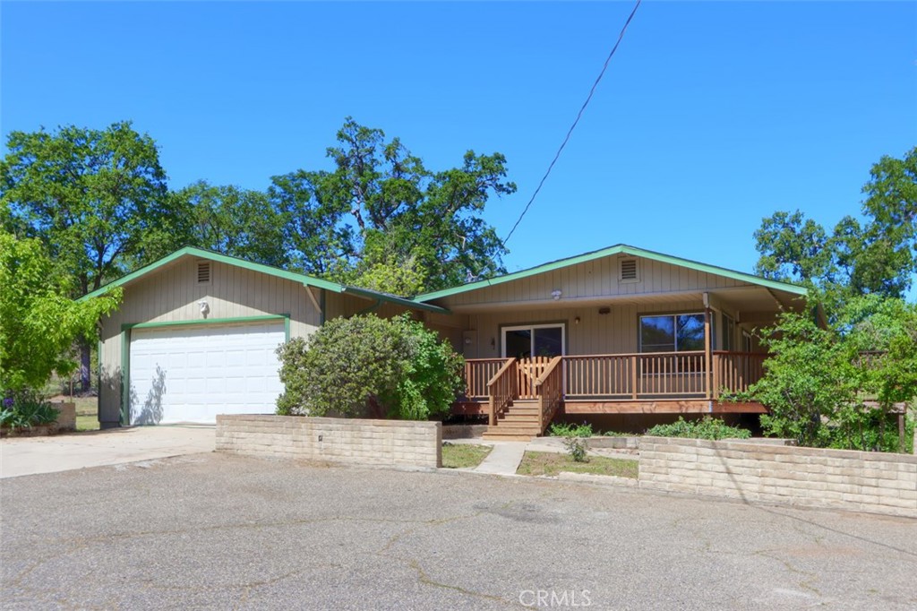 4949 Indian Peak Road Mariposa, CA 95338 - Photo 2 of 56 a front view of a house with a garden
