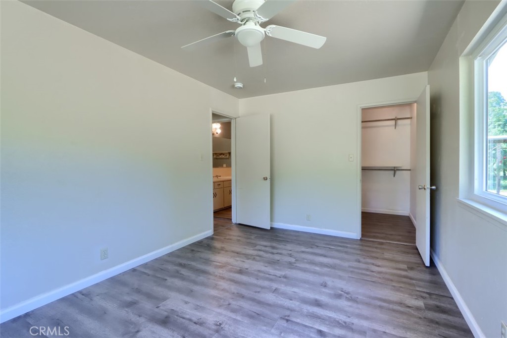 4949 Indian Peak Road Mariposa, CA 95338 - Photo 24 of 56 an empty room with wooden floor and windows