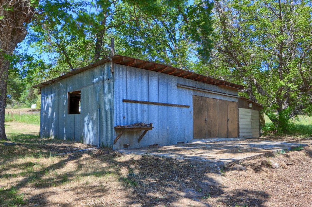 4949 Indian Peak Road Mariposa, CA 95338 - Photo 43 of 56 a backyard of a house with barbeque oven and wooden fence