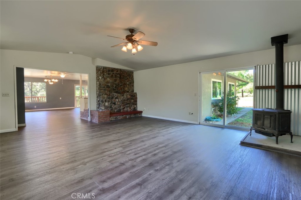 4949 Indian Peak Road Mariposa, CA 95338 - Photo 7 of 56 a view of a livingroom with wooden floor a ceiling fan and windows