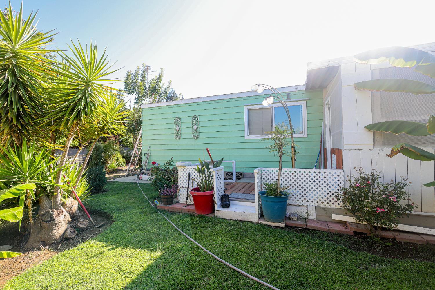 1300 West Olson Avenue, Unit 61 Reedley, CA 93654 - Photo 17 of 20 a view of a chair and table in backyard of the house