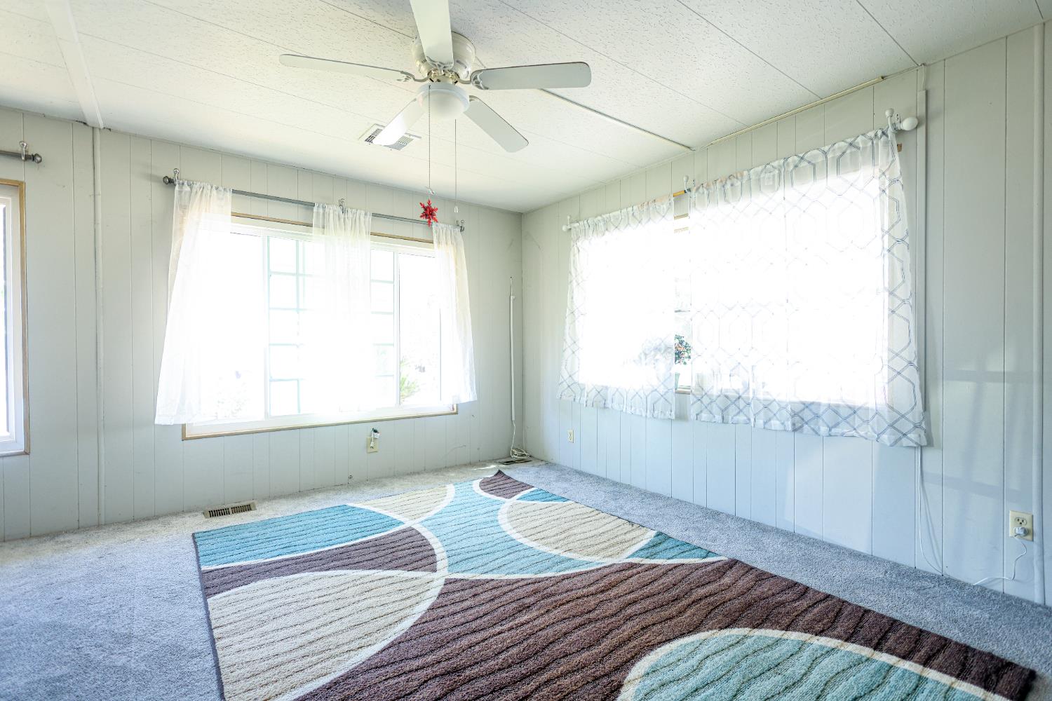 1300 West Olson Avenue, Unit 61 Reedley, CA 93654 - Photo 3 of 20 a bedroom with a bed and a window