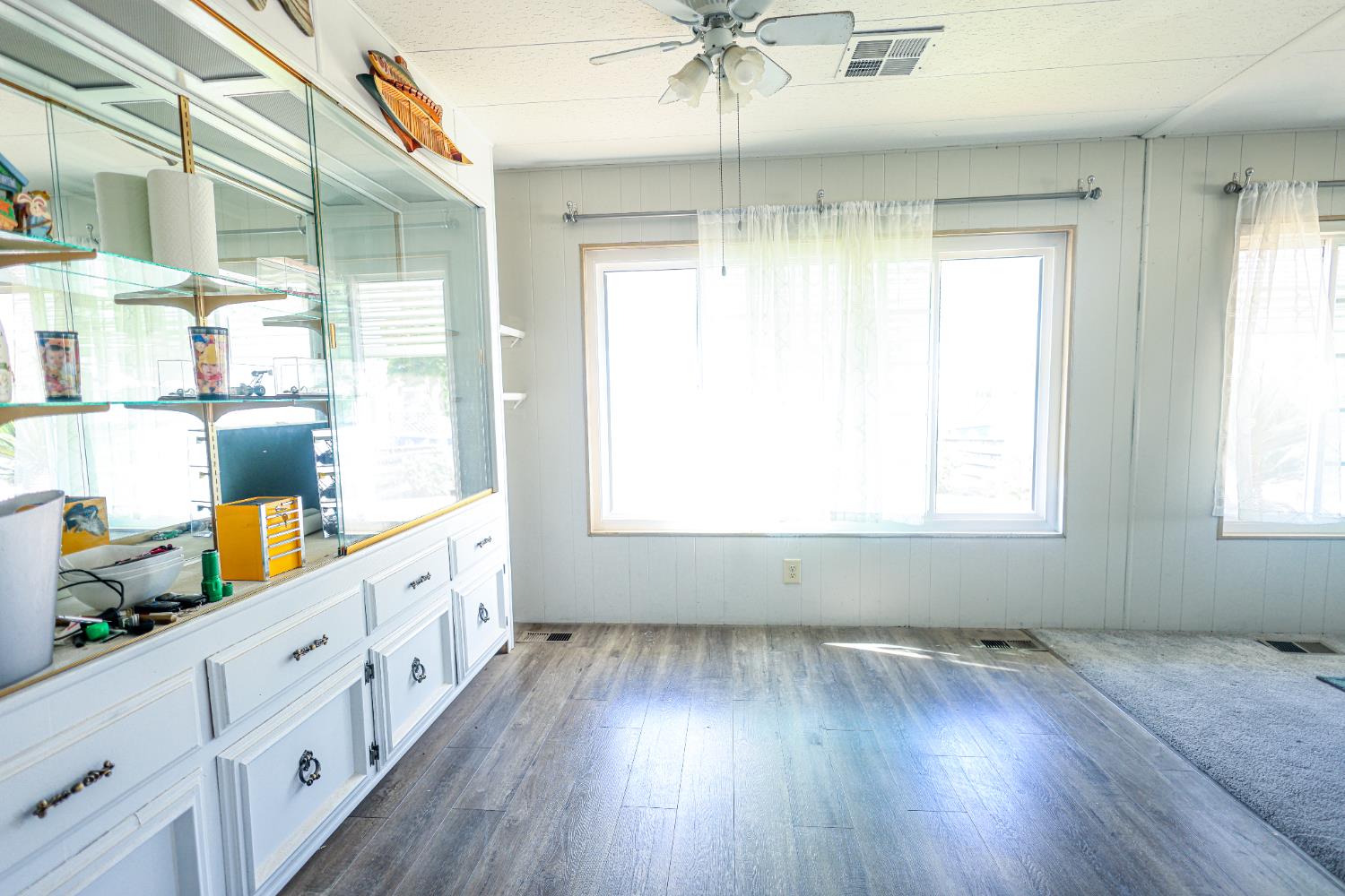 1300 West Olson Avenue, Unit 61 Reedley, CA 93654 - Photo 5 of 20 a view of an empty room with wooden floor and a window
