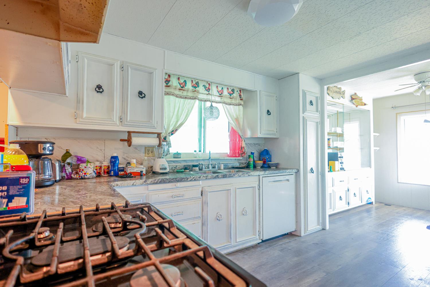 1300 West Olson Avenue, Unit 61 Reedley, CA 93654 - Photo 6 of 20 a kitchen with stainless steel appliances a stove a sink and a refrigerator