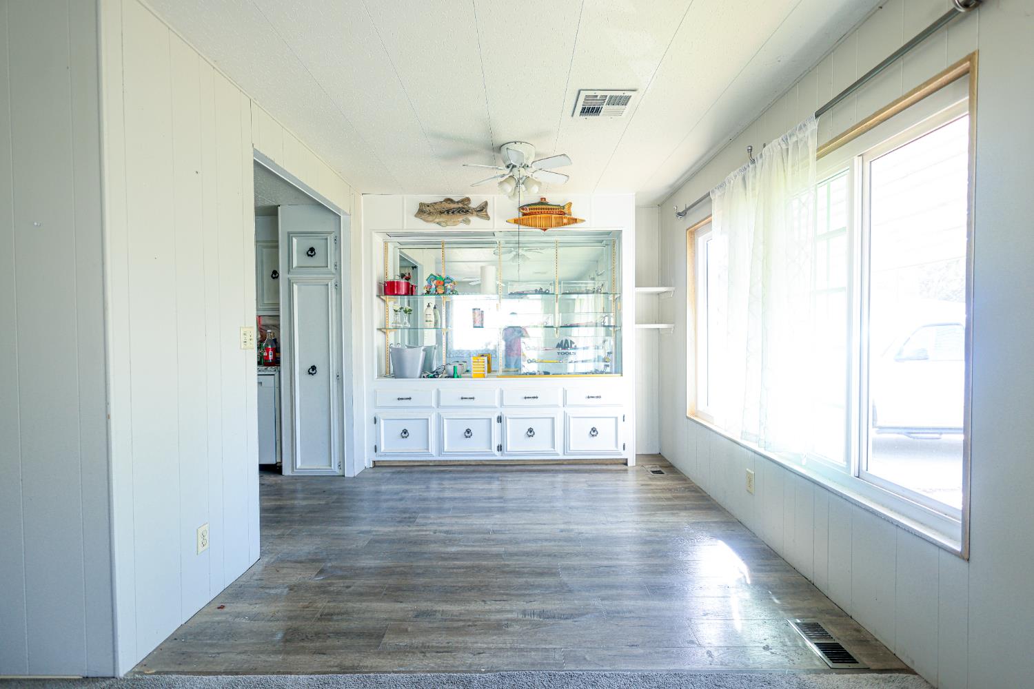 1300 West Olson Avenue, Unit 61 Reedley, CA 93654 - Photo 7 of 20 a view of a livingroom with wooden floor and windows