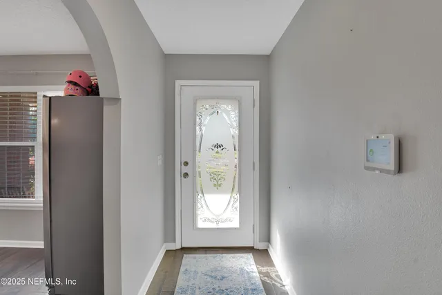 a hallway with window and mirror