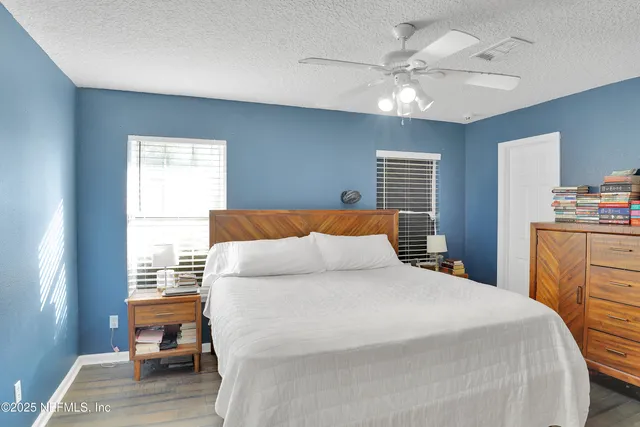 a bedroom with a large bed and a chandelier