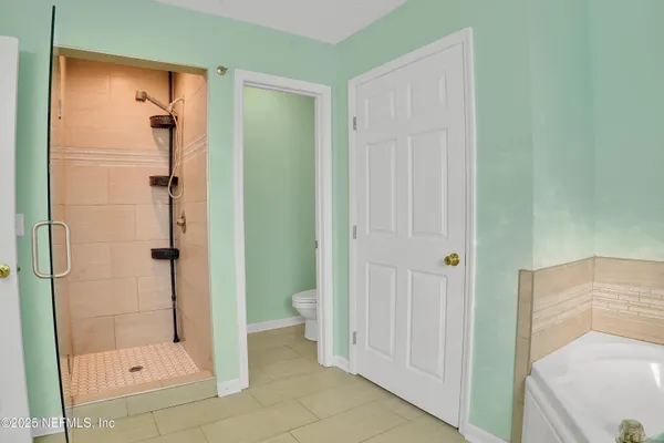 a bathroom with a shower and toilet